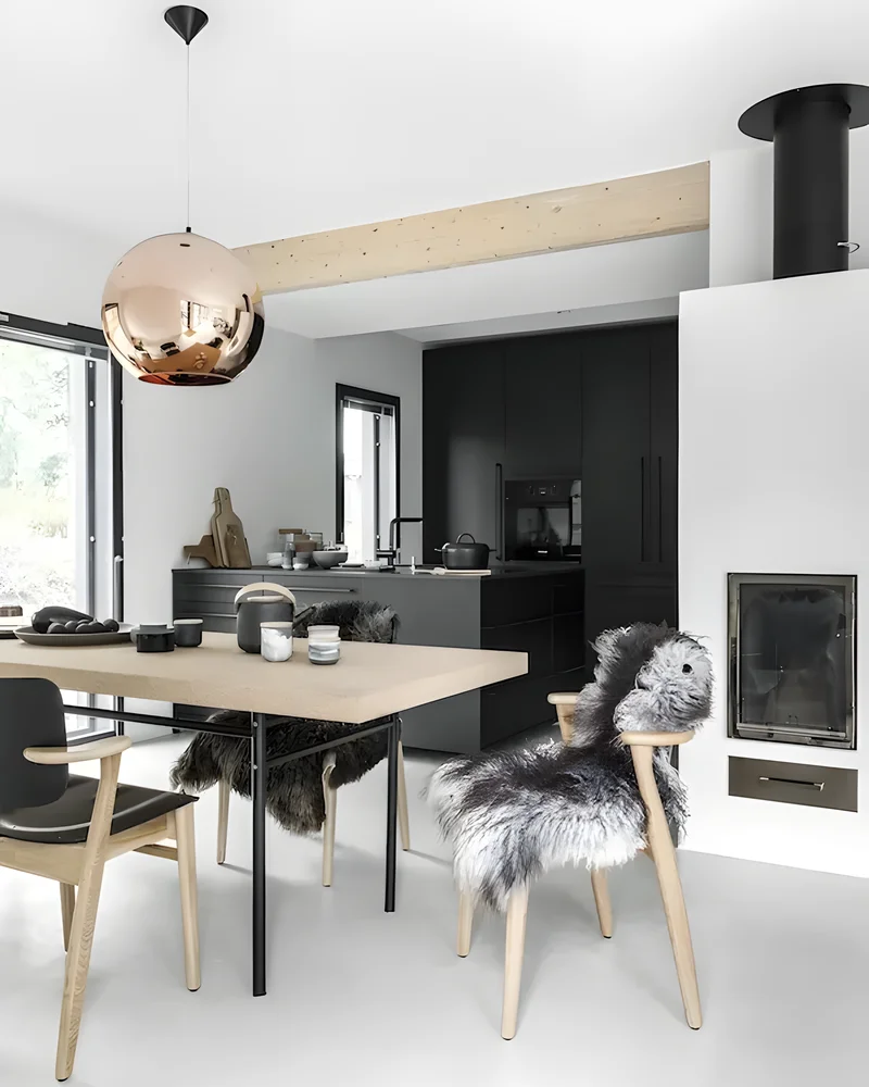 Salle à manger scandinave avec table en bois, chaises avec peau de mouton et suspension cuivrée